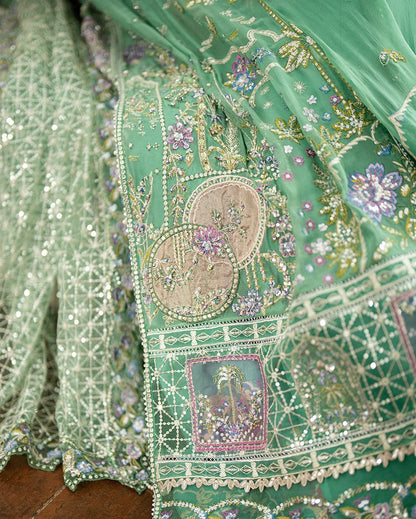 Shop this sea green chiffon suit with hand embellishments, sequinned net dupatta, raw silk trousers, and handcrafted tassels. Perfect for festive occasions!