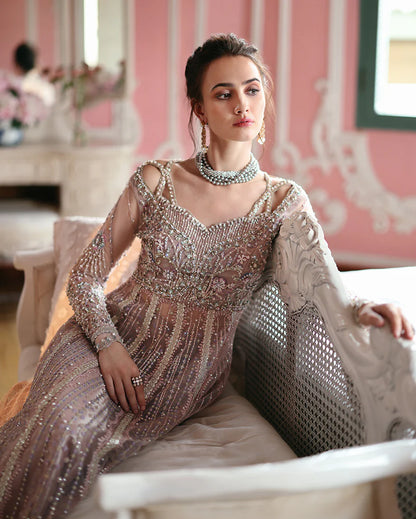 Luxury embroidered net shirt with sequins and pearls, paired with a dyed zari lehenga and embroidered net dupatta—perfect for weddings and festive occasions.