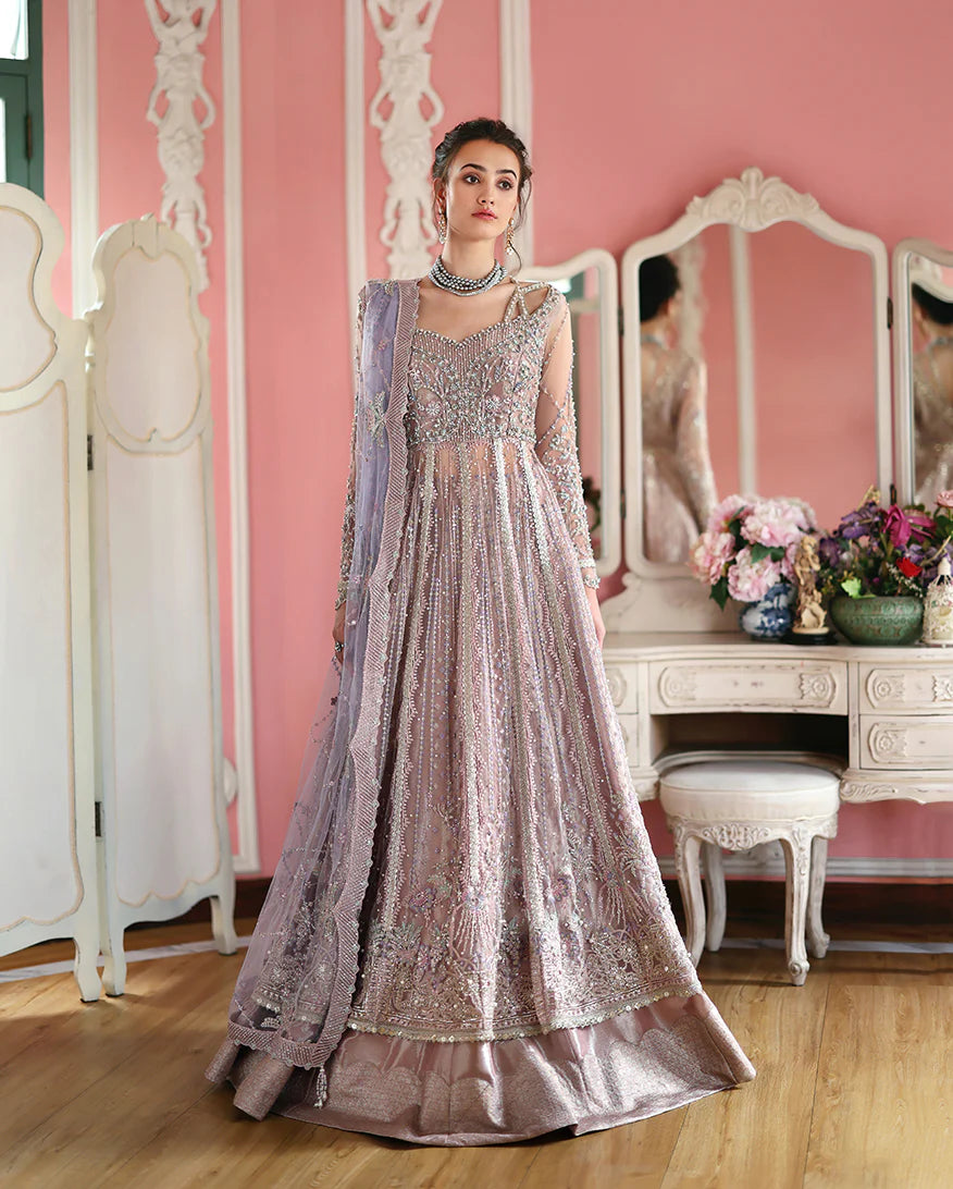 Luxury embroidered net shirt with sequins and pearls, paired with a dyed zari lehenga and embroidered net dupatta—perfect for weddings and festive occasions.