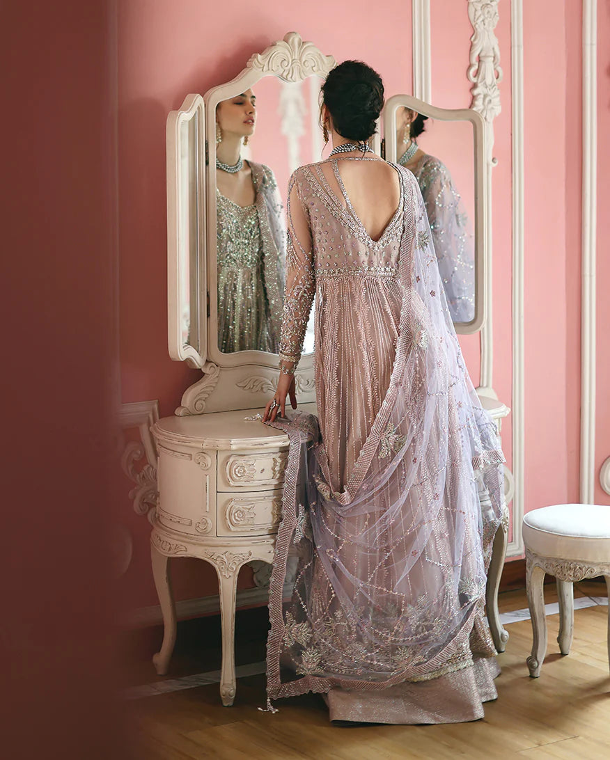 Luxury embroidered net shirt with sequins and pearls, paired with a dyed zari lehenga and embroidered net dupatta—perfect for weddings and festive occasions.