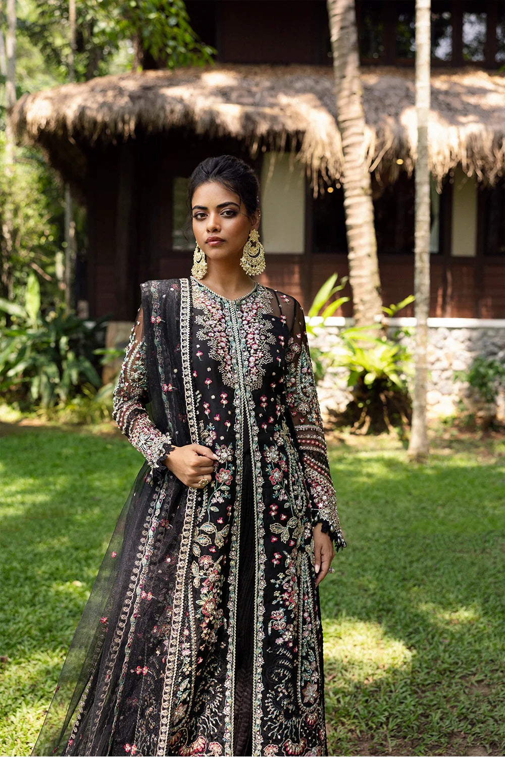 Elegant black 3-piece unstitched set in organza & net with hand and machine embroidery, including raw silk trouser and dupatta, perfect for weddings and festive events.