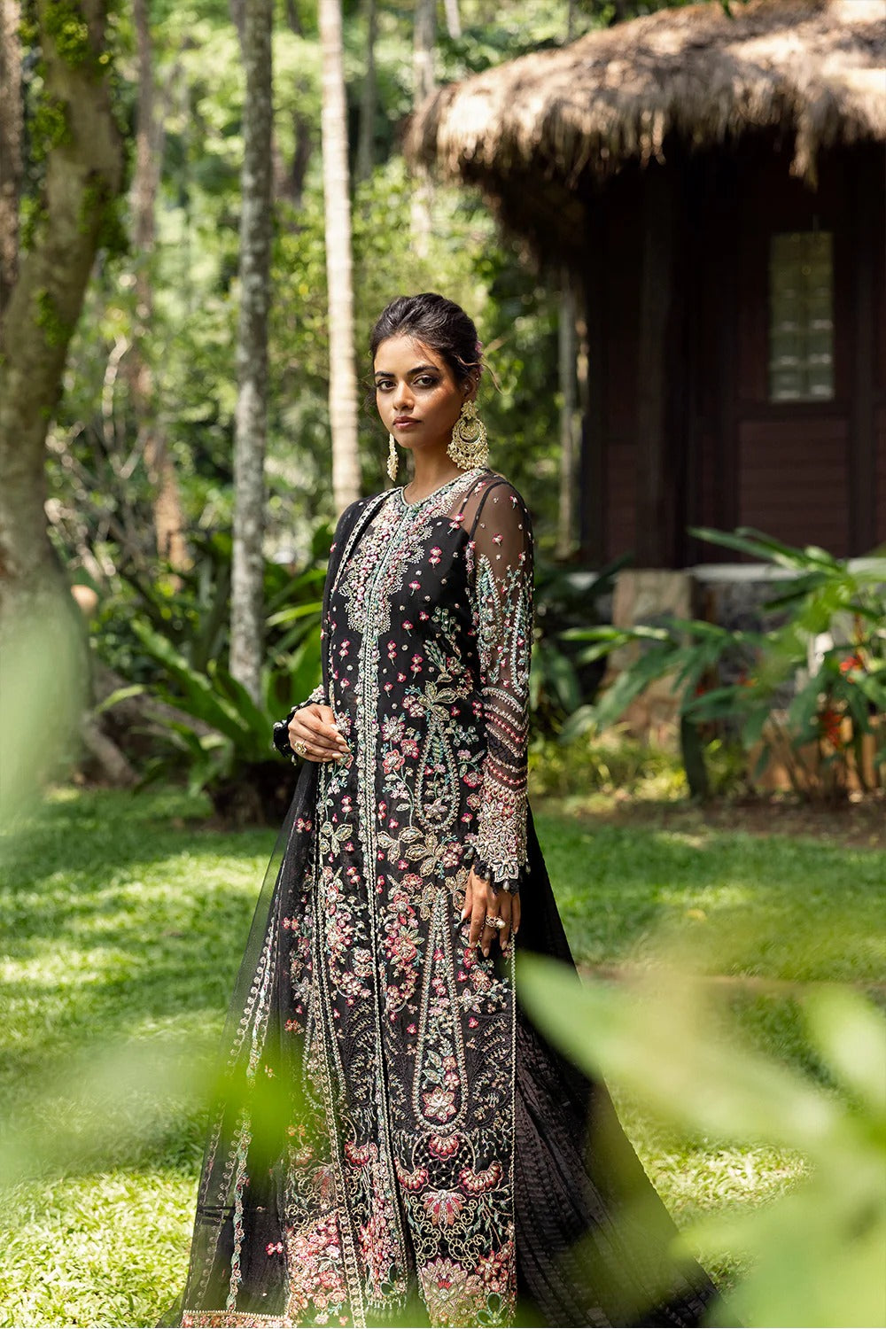 Elegant black 3-piece unstitched set in organza & net with hand and machine embroidery, including raw silk trouser and dupatta, perfect for weddings and festive events.