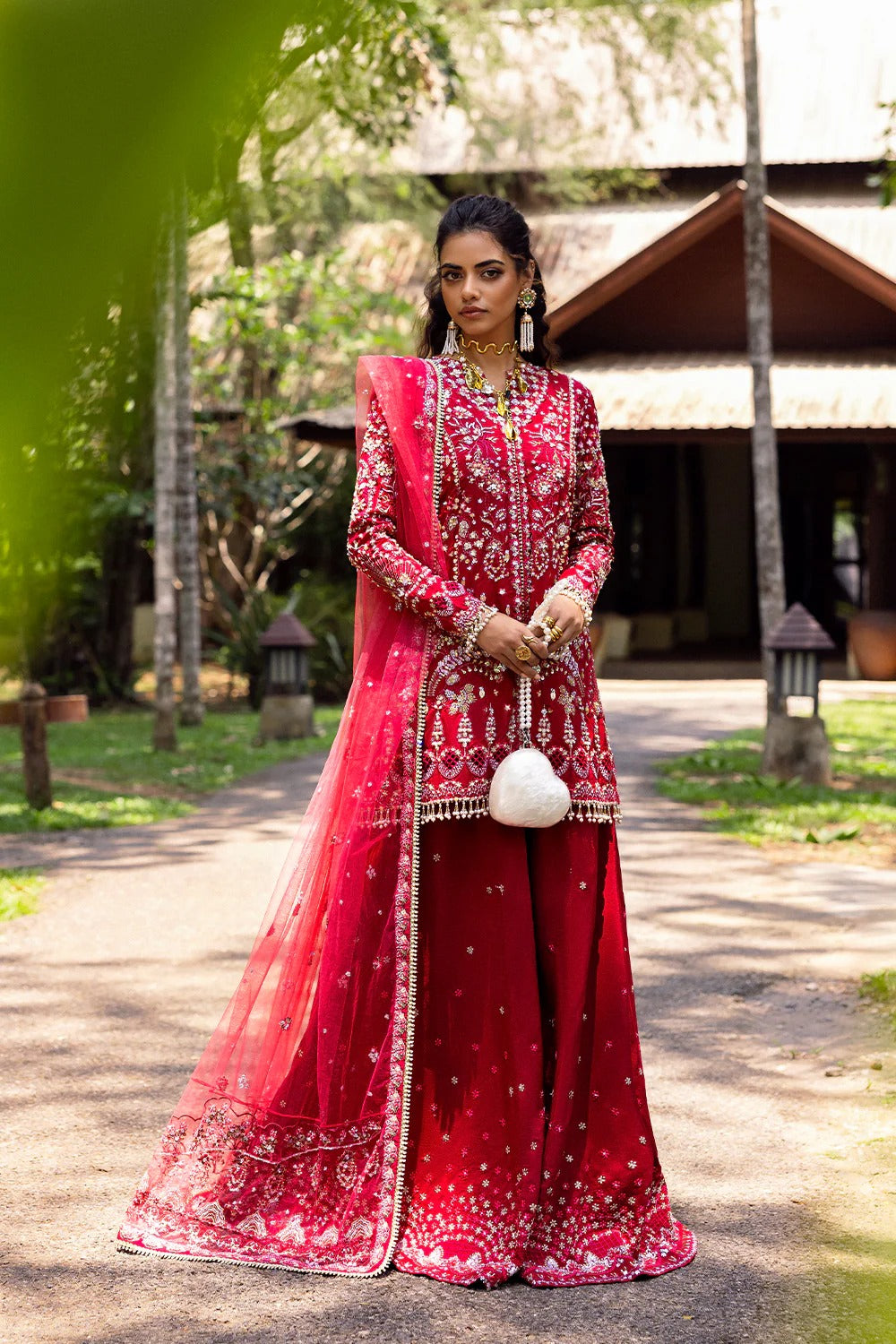 Stunning fuchsia pink 3-piece unstitched set in raw silk & net with hand and machine embroidery, including embroidered trouser and dupatta for festive occasions.
