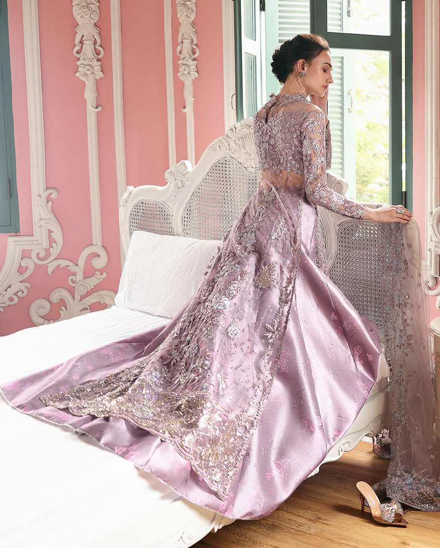 Hand-embellished embroidered net shirt with sequins, paired with a printed silk lehenga and embroidered net dupatta—perfect for weddings & festive wear.