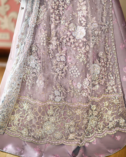 Hand-embellished embroidered net shirt with sequins, paired with a printed silk lehenga and embroidered net dupatta—perfect for weddings & festive wear.