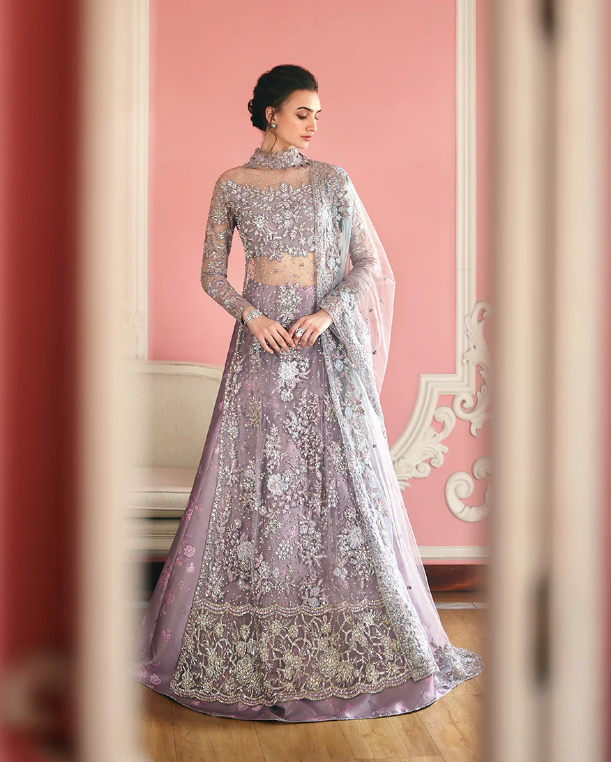 Hand-embellished embroidered net shirt with sequins, paired with a printed silk lehenga and embroidered net dupatta—perfect for weddings & festive wear.