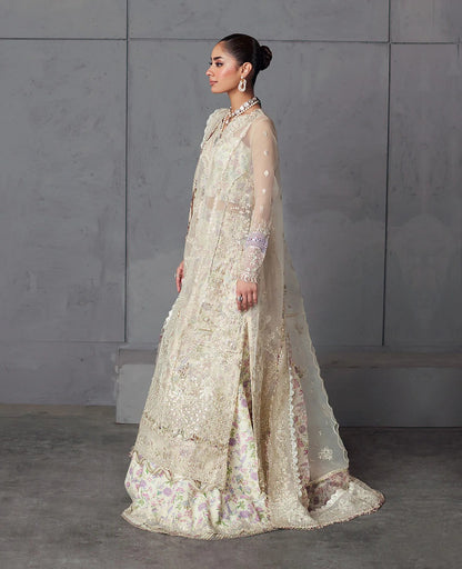 Edera exudes purity in white with hand-embellished organza panels, lilac-pink florals, and a scalloped embroidered dupatta — a vision of grace and artistry.