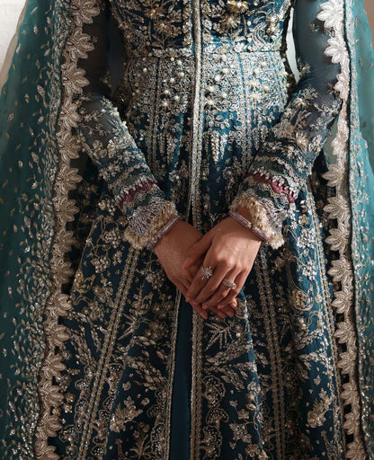 Grace meets glamour in this sage organza pishwas adorned with silver florals, sequins, and adda detailing — a timeless ode to feminine elegance and charm.