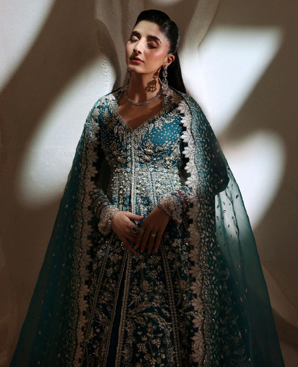 Grace meets glamour in this sage organza pishwas adorned with silver florals, sequins, and adda detailing — a timeless ode to feminine elegance and charm.