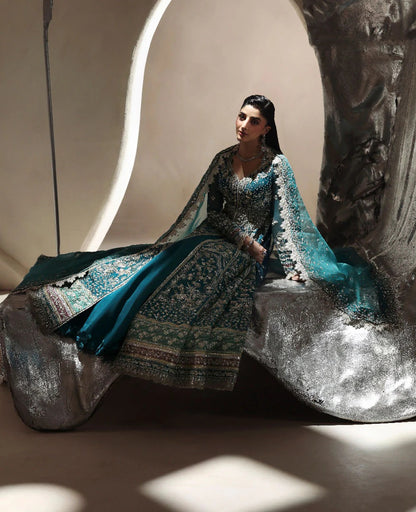 Grace meets glamour in this sage organza pishwas adorned with silver florals, sequins, and adda detailing — a timeless ode to feminine elegance and charm.