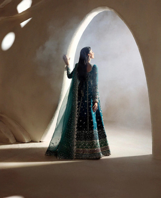 Grace meets glamour in this sage organza pishwas adorned with silver florals, sequins, and adda detailing — a timeless ode to feminine elegance and charm.