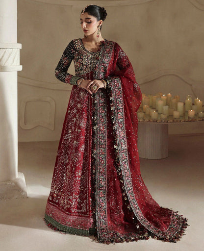 Bold yet timeless, this black and red organza gown features hand embroidery, silver sequins, and a shimmering dupatta — a masterpiece of modern elegance.