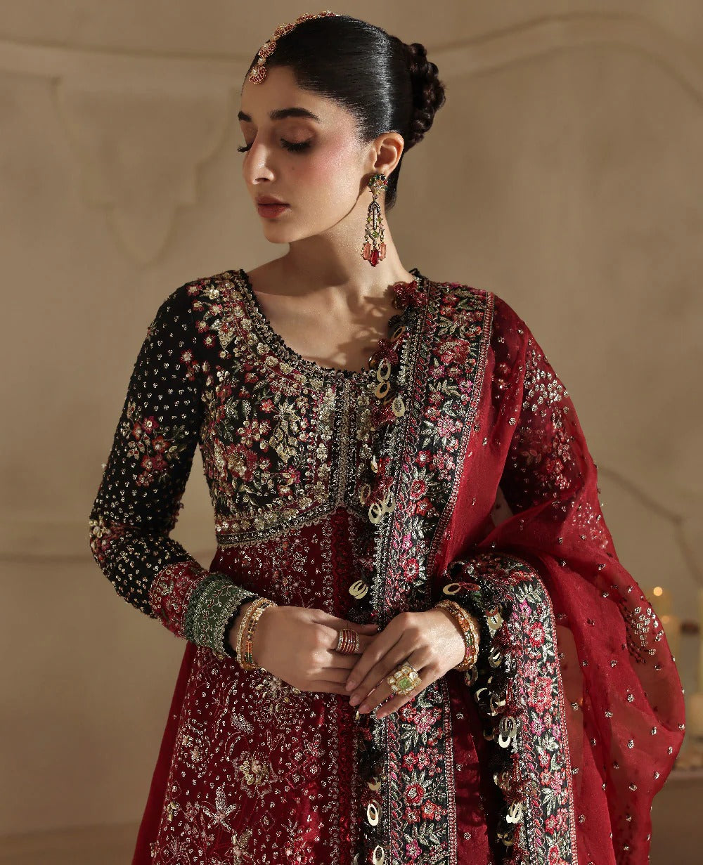 Bold yet timeless, this black and red organza gown features hand embroidery, silver sequins, and a shimmering dupatta — a masterpiece of modern elegance.
