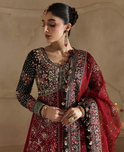 Bold yet timeless, this black and red organza gown features hand embroidery, silver sequins, and a shimmering dupatta — a masterpiece of modern elegance.