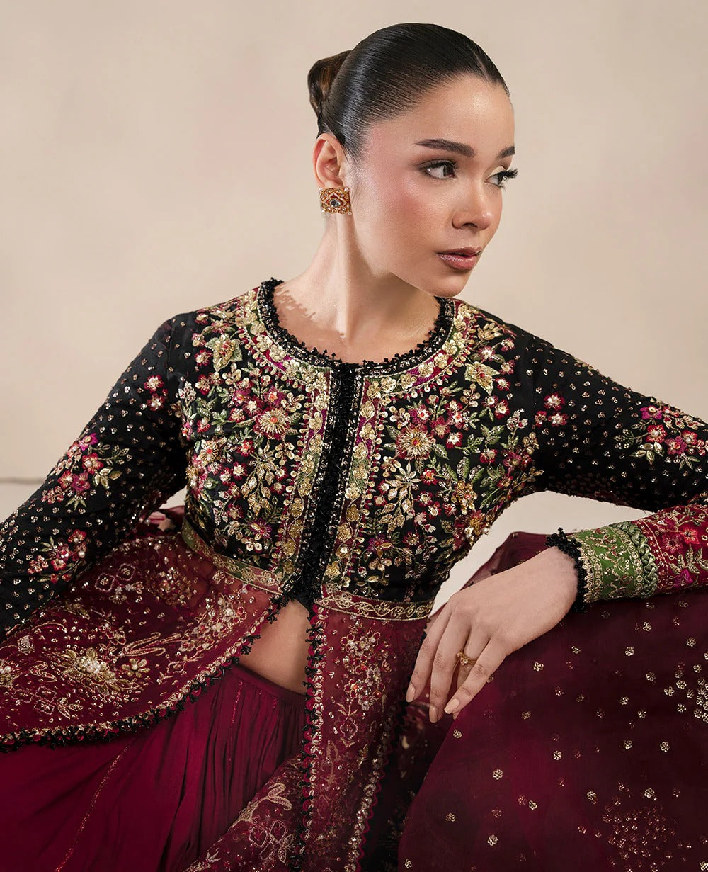 Bold yet timeless, this black and red organza gown features hand embroidery, silver sequins, and a shimmering dupatta — a masterpiece of modern elegance.