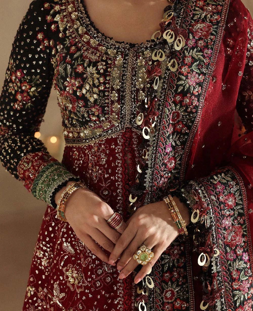 Bold yet timeless, this black and red organza gown features hand embroidery, silver sequins, and a shimmering dupatta — a masterpiece of modern elegance.