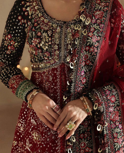 Bold yet timeless, this black and red organza gown features hand embroidery, silver sequins, and a shimmering dupatta — a masterpiece of modern elegance.