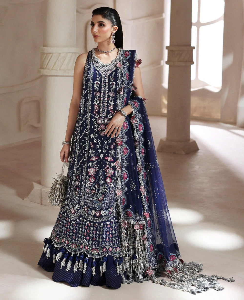 Discover elegance in this paneled net gown featuring classic shikargah motifs, shimmering sequins, scalloped hem, and an ethereal dupatta for timeless grace.