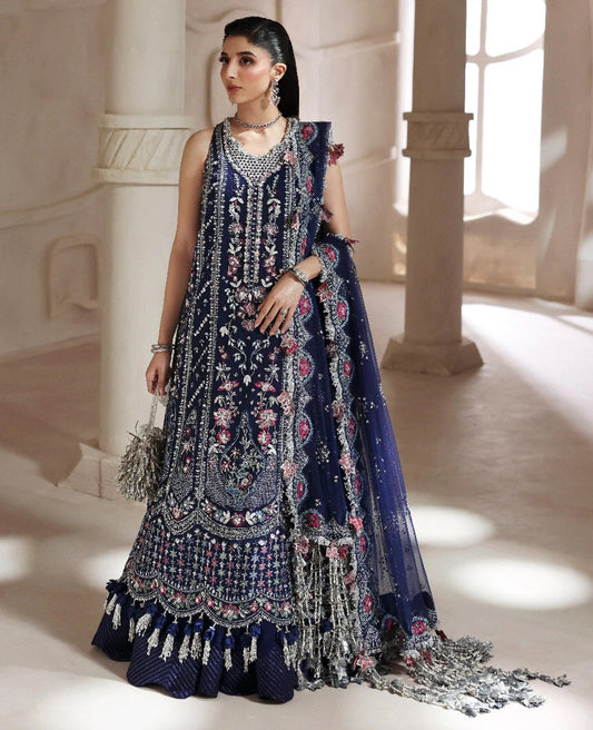 Discover elegance in this paneled net gown featuring classic shikargah motifs, shimmering sequins, scalloped hem, and an ethereal dupatta for timeless grace.