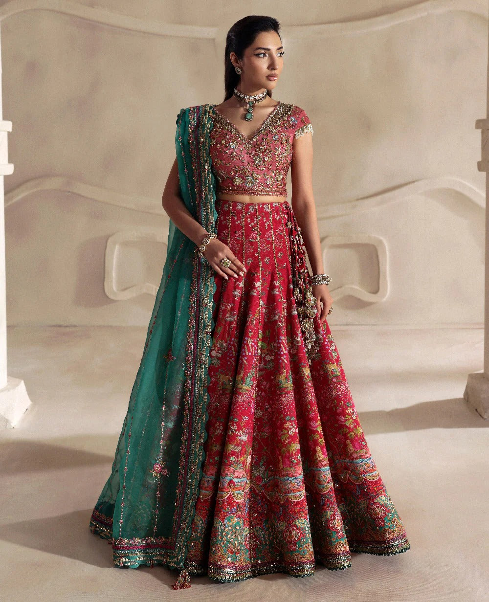 Radiant hot pink raw silk lehenga with a shikargah blouse, golden adda work, and teal embroidered dupatta — a bold, regal blend of color, craft, and heritage.