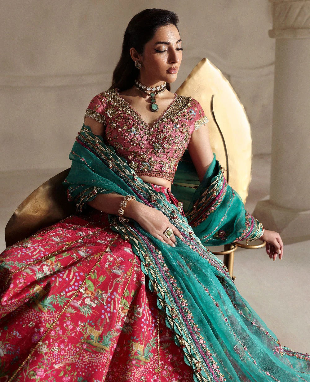 Radiant hot pink raw silk lehenga with a shikargah blouse, golden adda work, and teal embroidered dupatta — a bold, regal blend of color, craft, and heritage.