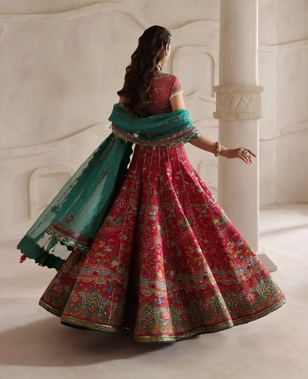 Radiant hot pink raw silk lehenga with a shikargah blouse, golden adda work, and teal embroidered dupatta — a bold, regal blend of color, craft, and heritage.