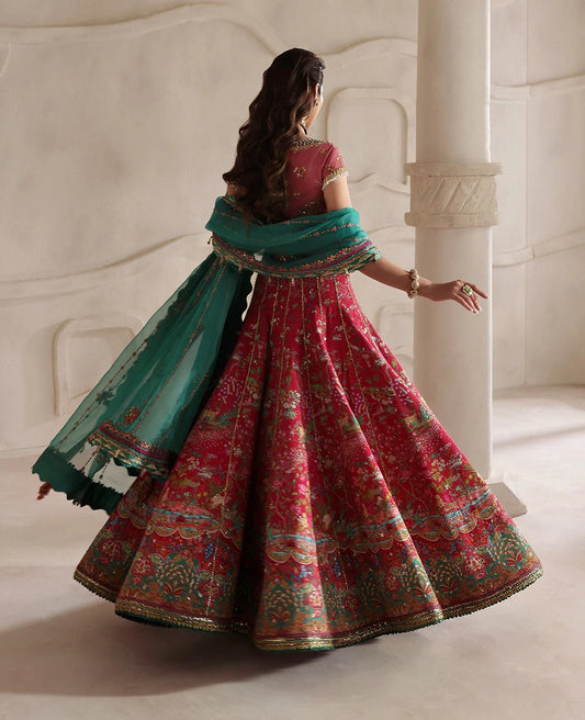 Radiant hot pink raw silk lehenga with a shikargah blouse, golden adda work, and teal embroidered dupatta — a bold, regal blend of color, craft, and heritage.