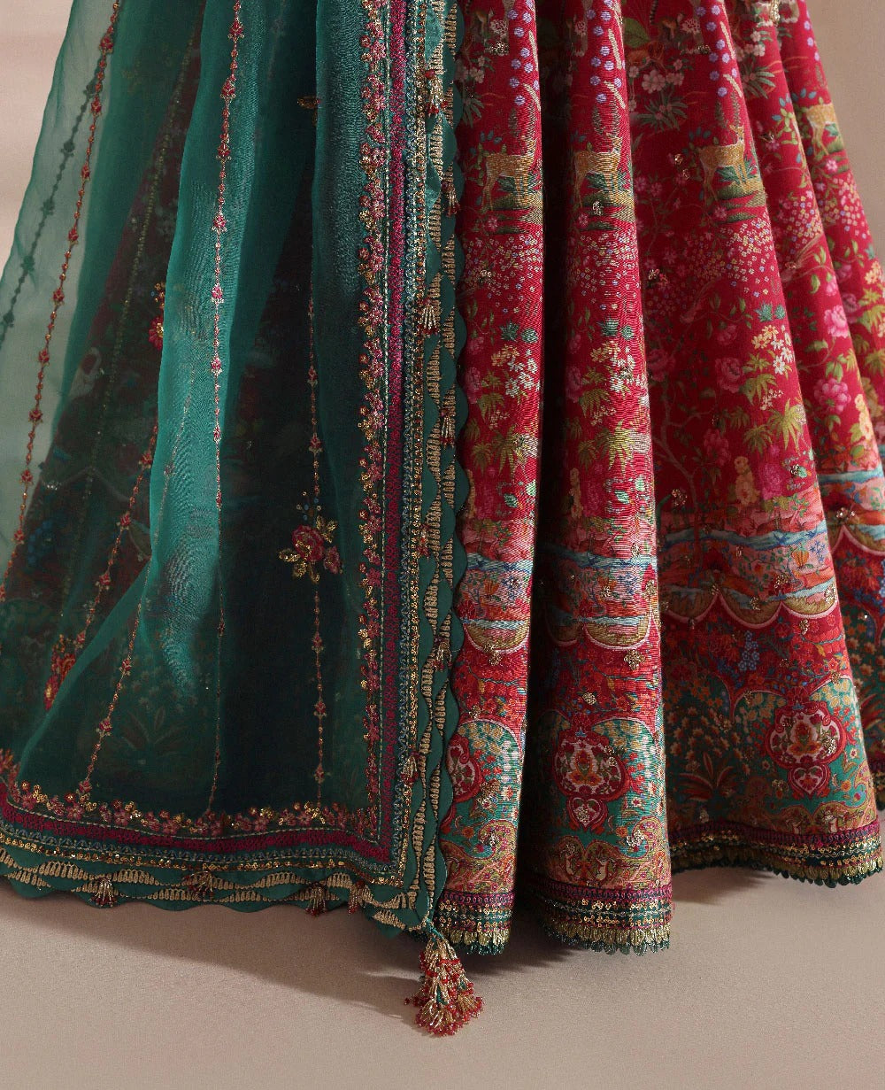 Radiant hot pink raw silk lehenga with a shikargah blouse, golden adda work, and teal embroidered dupatta — a bold, regal blend of color, craft, and heritage.