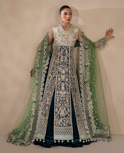 Ethereal white net shirt with blush florals, sequin accents, and a sage dupatta paired with a green lehenga — a perfect blend of grace, charm, and celebration