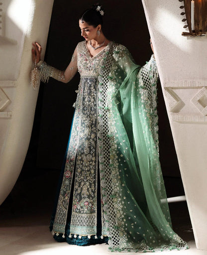 Ethereal white net shirt with blush florals, sequin accents, and a sage dupatta paired with a green lehenga — a perfect blend of grace, charm, and celebration