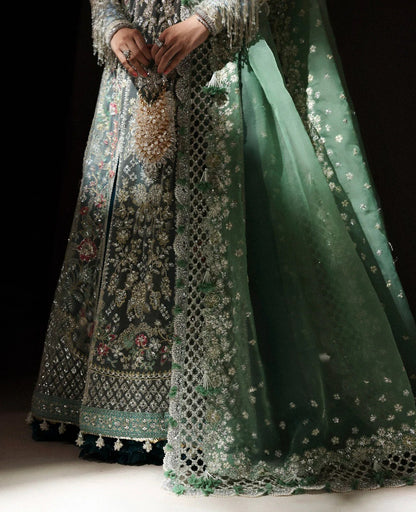 Ethereal white net shirt with blush florals, sequin accents, and a sage dupatta paired with a green lehenga — a perfect blend of grace, charm, and celebration