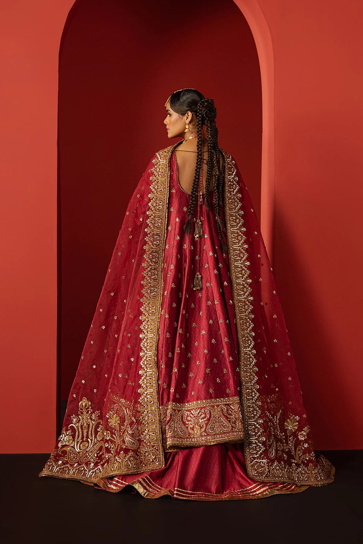 Stunning coral red raw silk suit with digital printed embroidery, elegant front and back panels, and a matching organza dupatta—ideal for festive and formal occasions.
