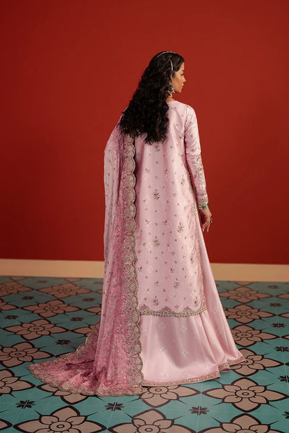 A stunning pastel pink raw silk suit featuring digital printed embroidery, elegant panel work, and a composed printed dupatta—perfect for chic festive and formal wear.