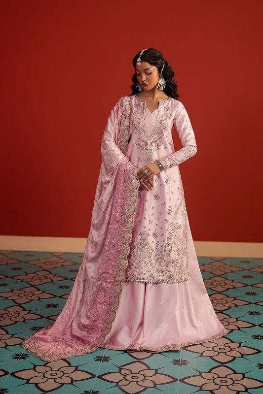 A stunning pastel pink raw silk suit featuring digital printed embroidery, elegant panel work, and a composed printed dupatta—perfect for chic festive and formal wear.