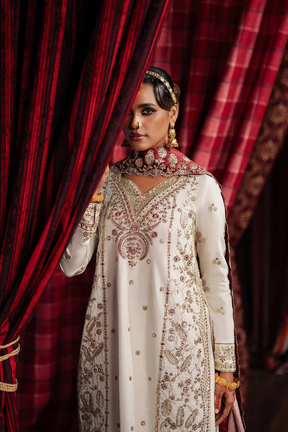 Elegant ivory raw silk suit featuring embroidered front and back panels, digital printed silk dupatta, and matching trousers—perfect for festive and formal occasions.