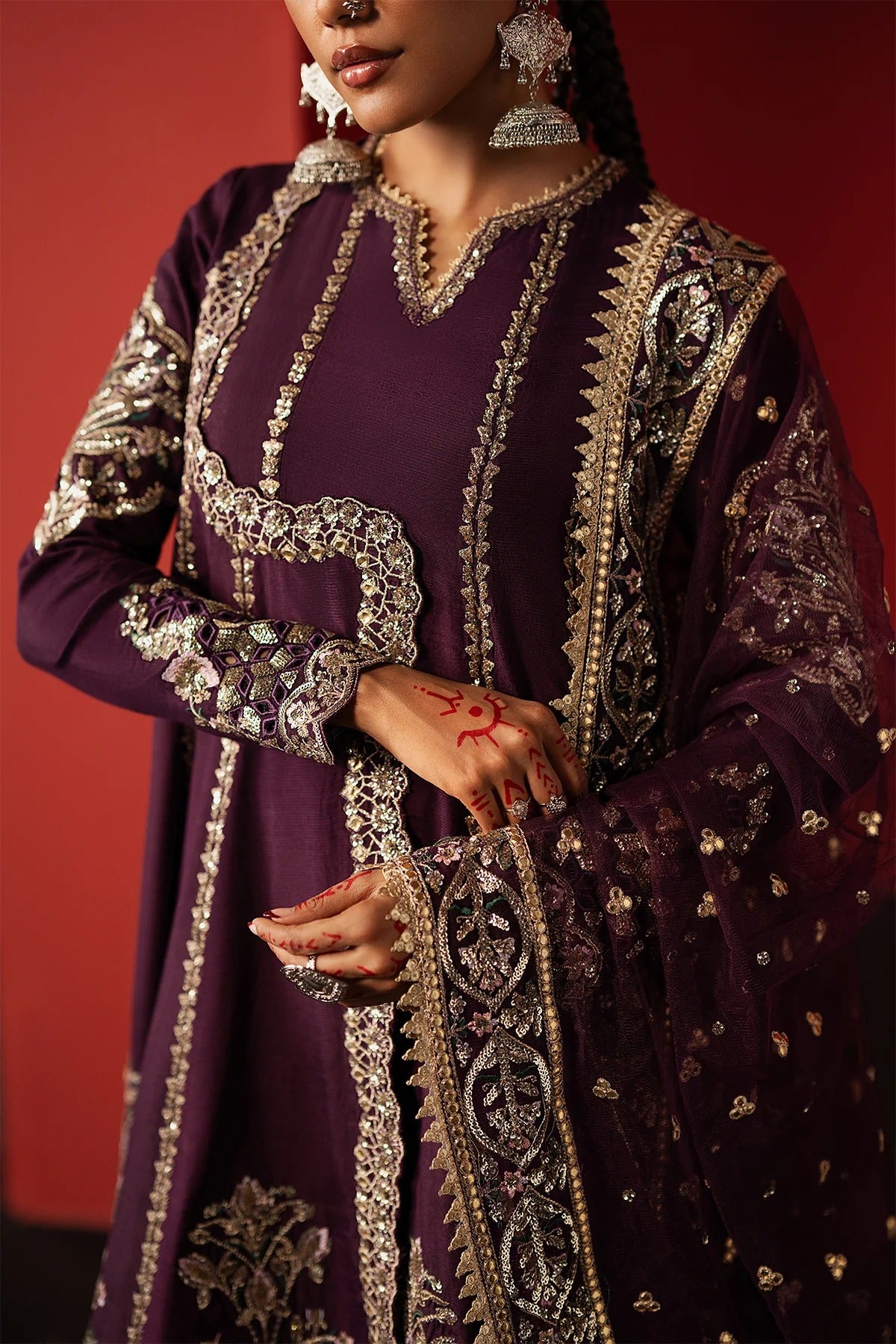 Experience elegance with this purple raw silk embroidered suit featuring premium panels, organza borders, and a net dupatta—perfect for festive and formal wear.