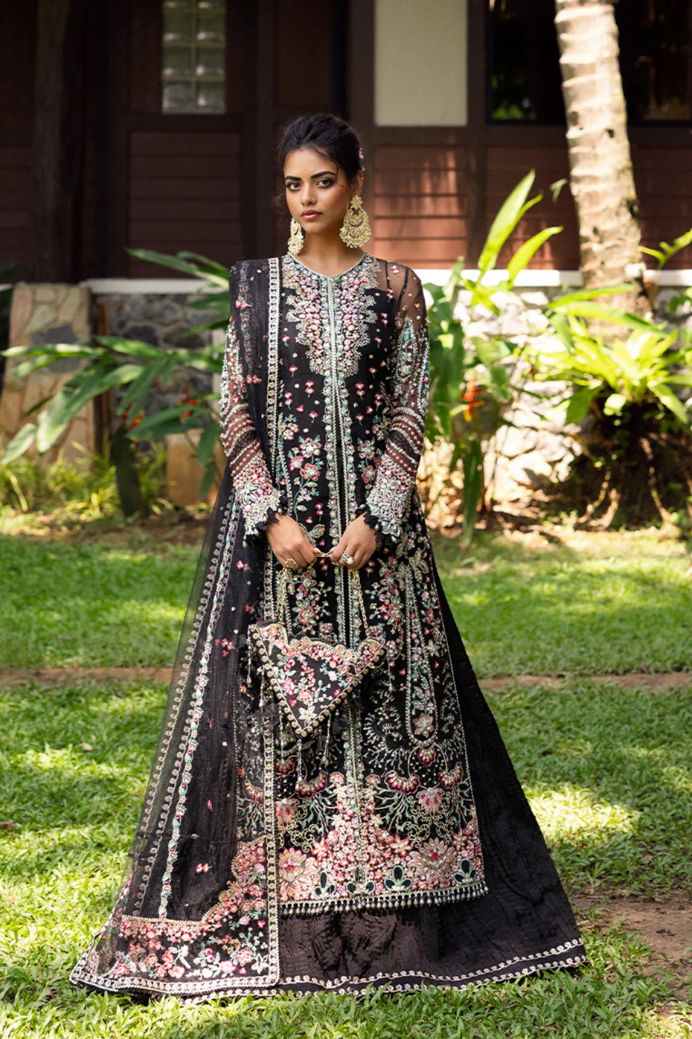 Elegant black 3-piece unstitched set in organza & net with hand and machine embroidery, including raw silk trouser and dupatta, perfect for weddings and festive events.