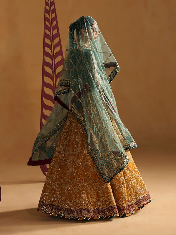 Luxury lehenga set featuring embroidered net bodice, sequined sleeves, organza panels, raw silk borders, detailed adda work, and matching embellished dupatta.