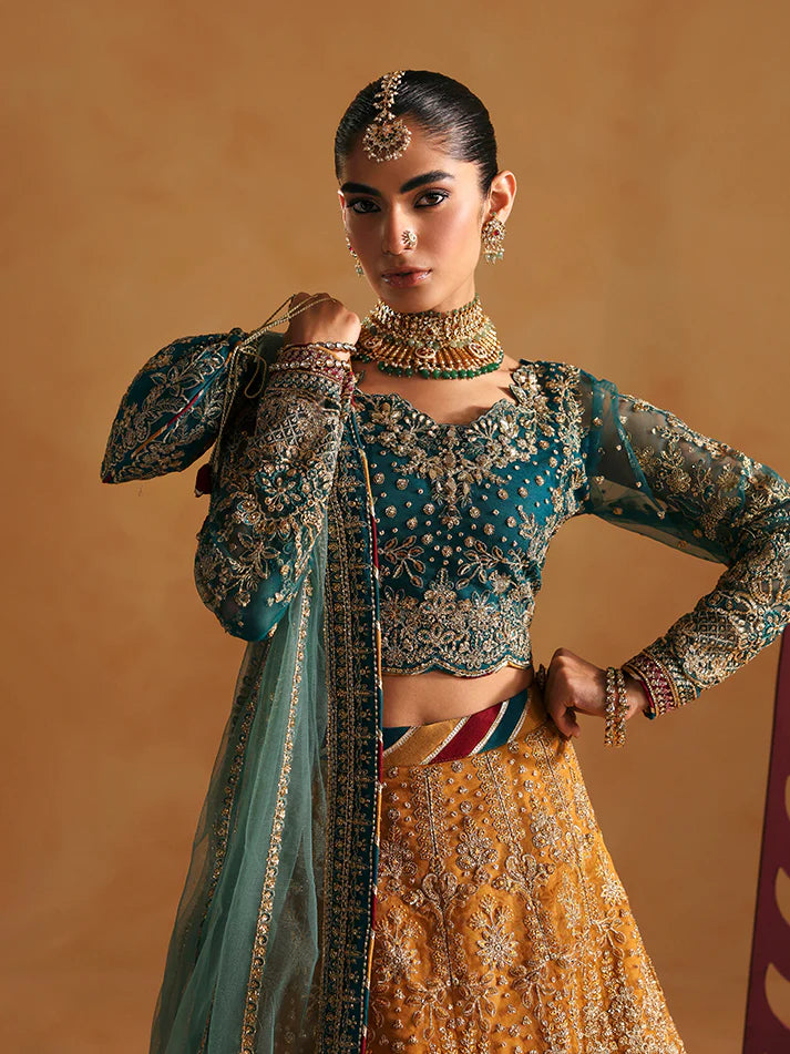 Luxury lehenga set featuring embroidered net bodice, sequined sleeves, organza panels, raw silk borders, detailed adda work, and matching embellished dupatta.