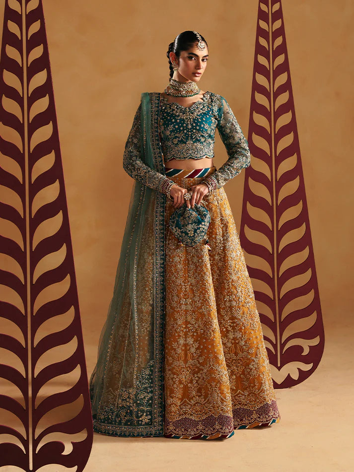 Luxury lehenga set featuring embroidered net bodice, sequined sleeves, organza panels, raw silk borders, detailed adda work, and matching embellished dupatta.