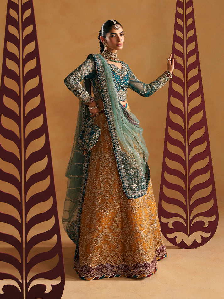 Luxury lehenga set featuring embroidered net bodice, sequined sleeves, organza panels, raw silk borders, detailed adda work, and matching embellished dupatta.