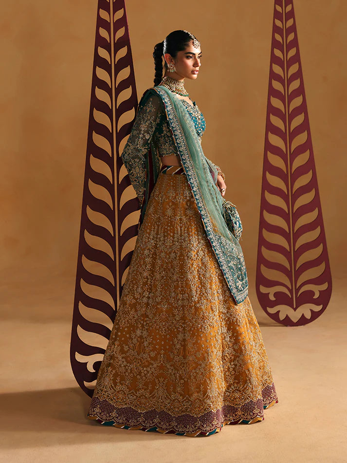 Luxury lehenga set featuring embroidered net bodice, sequined sleeves, organza panels, raw silk borders, detailed adda work, and matching embellished dupatta.