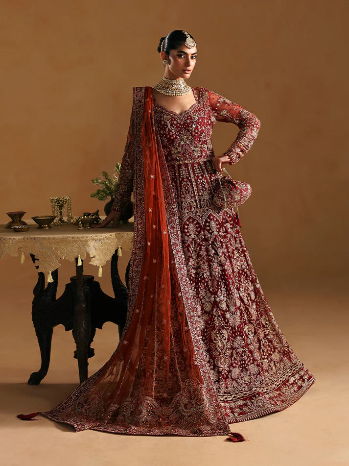 Elegant kalidaar pishwas featuring adda-worked net bodice, sequined panels, embroidered sleeves, raw silk lehnga, and dupatta ensemble.