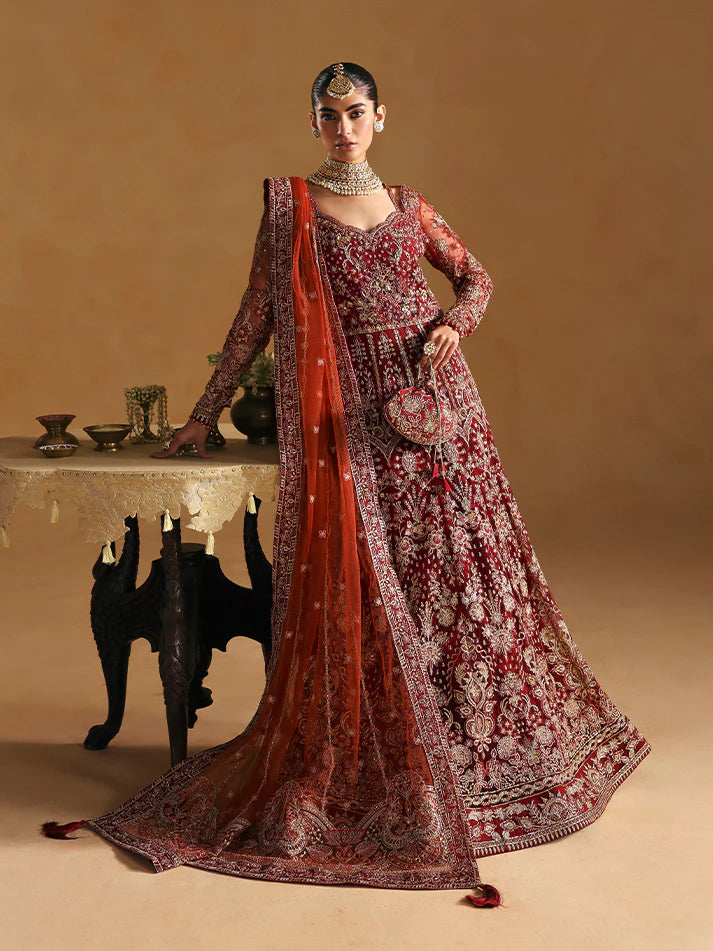 Elegant kalidaar pishwas featuring adda-worked net bodice, sequined panels, embroidered sleeves, raw silk lehnga, and dupatta ensemble.