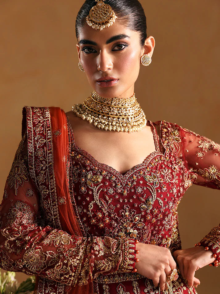Elegant kalidaar pishwas featuring adda-worked net bodice, sequined panels, embroidered sleeves, raw silk lehnga, and dupatta ensemble.