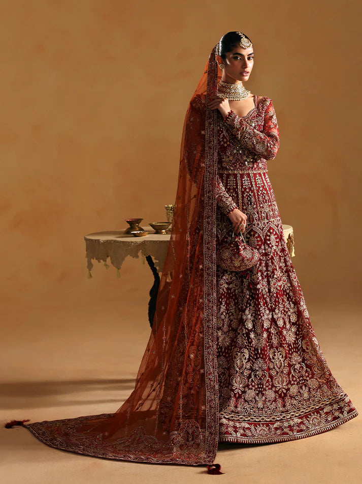 Elegant kalidaar pishwas featuring adda-worked net bodice, sequined panels, embroidered sleeves, raw silk lehnga, and dupatta ensemble.