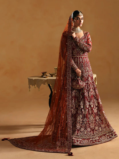 Elegant kalidaar pishwas featuring adda-worked net bodice, sequined panels, embroidered sleeves, raw silk lehnga, and dupatta ensemble.