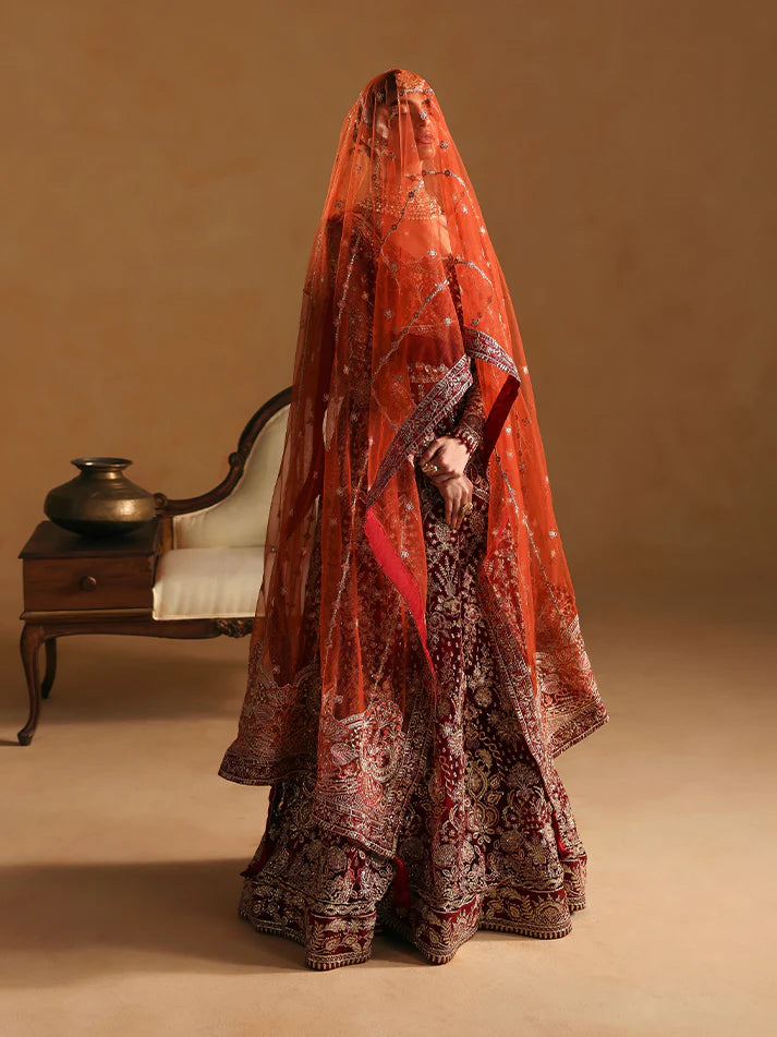 Elegant kalidaar pishwas featuring adda-worked net bodice, sequined panels, embroidered sleeves, raw silk lehnga, and dupatta ensemble.