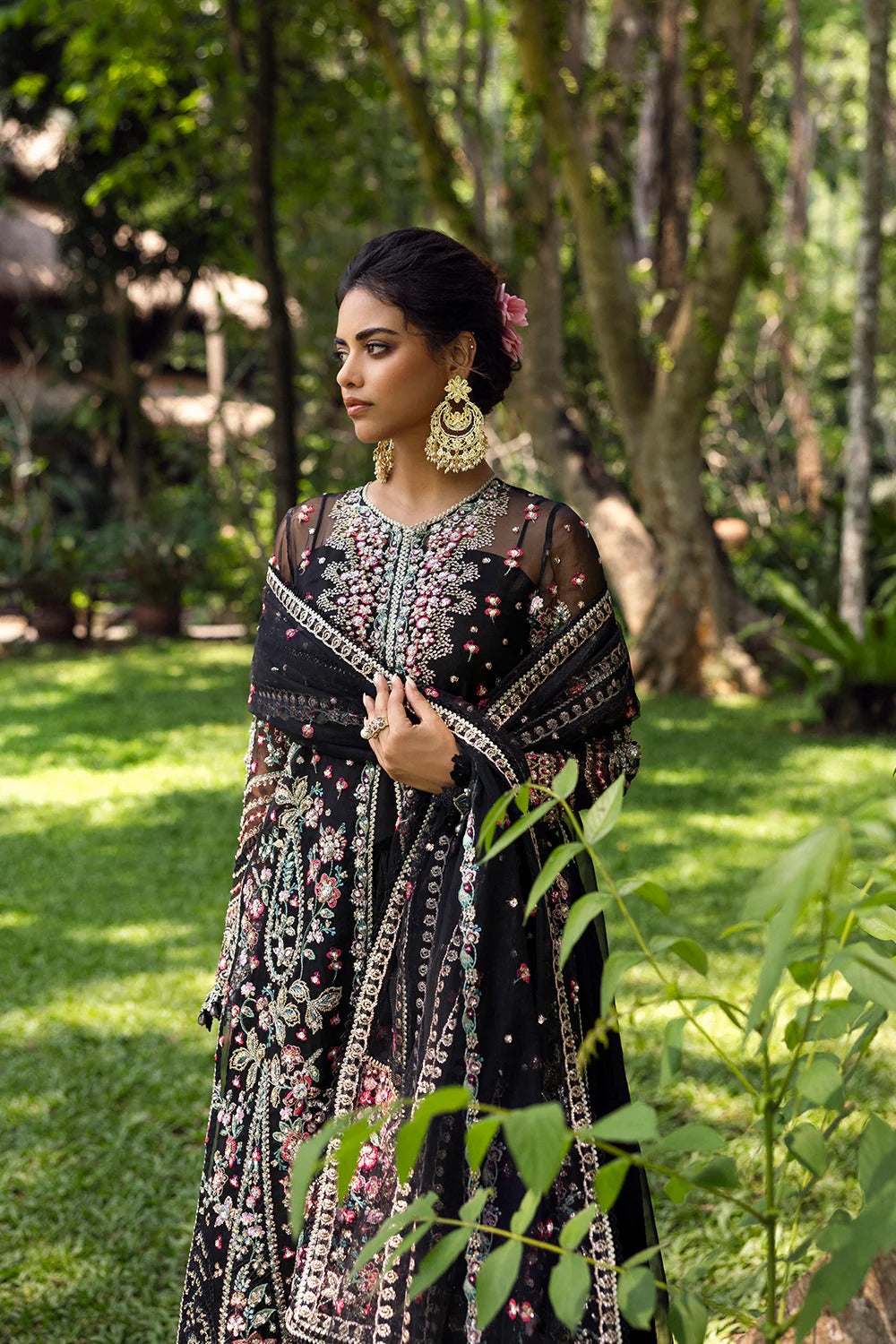 Elegant black 3-piece unstitched set in organza & net with hand and machine embroidery, including raw silk trouser and dupatta, perfect for weddings and festive events.