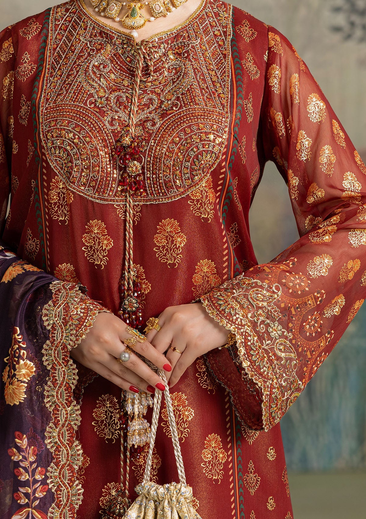 Elegant foil printed chiffon dress with embroidered organza neckline, borders and sleeves. Paired with masoori silk pants and foil printed silk dupatta.